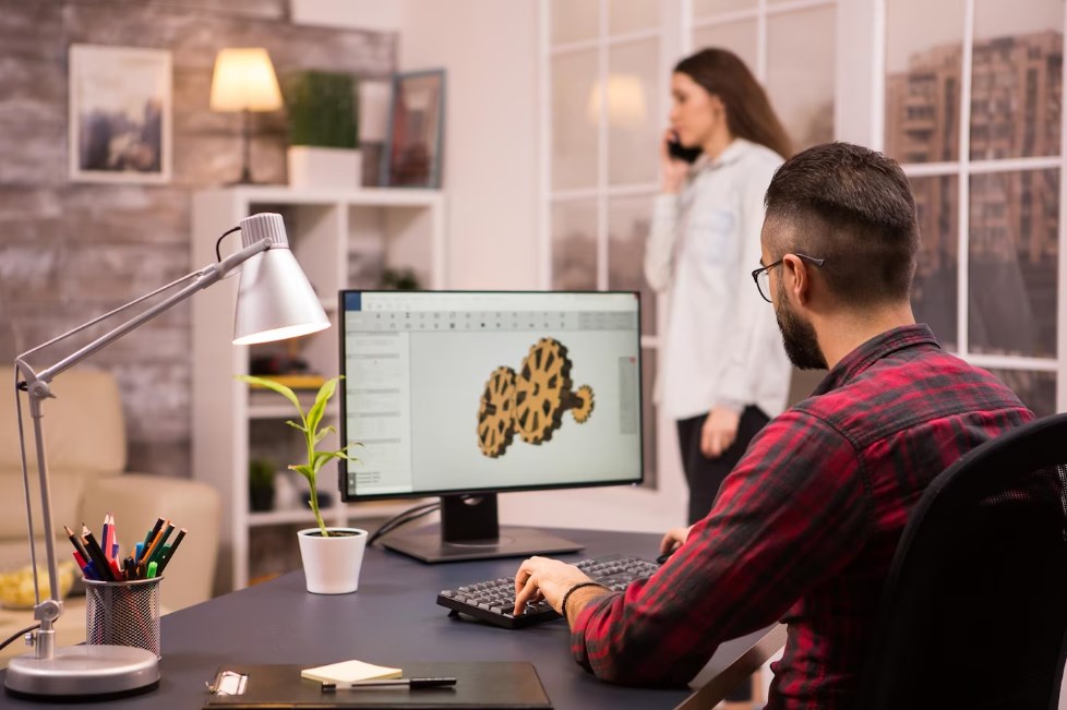 a designer drawing a mechanical prototype using software for 3D modeling