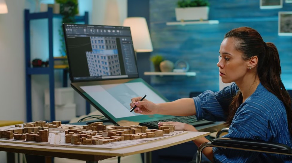 a female architect working on a 3D construction layout and using a touch screen